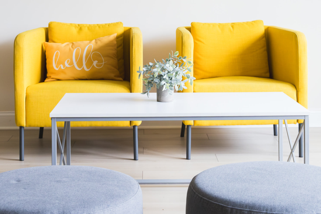 Two yellow armchairs and a coffee table in the Kuehnel Psychological Services waiting area