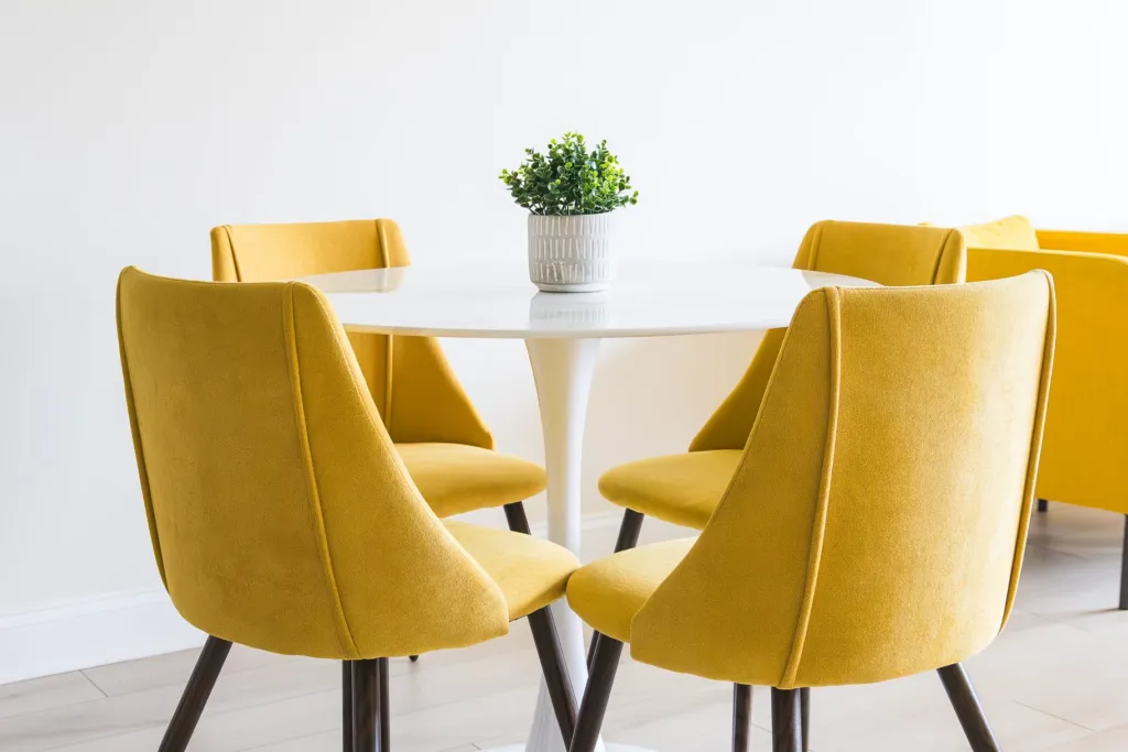 A round white table with yellow chairs in the Kuehnel Psychological Services office