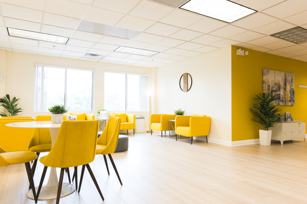 The bright waiting area at the Franklin office, with yellow armchairs and tall windows